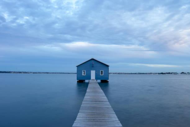 istock Blue Boat House In Perth at cloudy sunset 1058746620