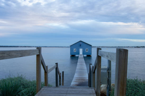 istock Blue Boat House In Perth at cloudy sunset 1058746672
