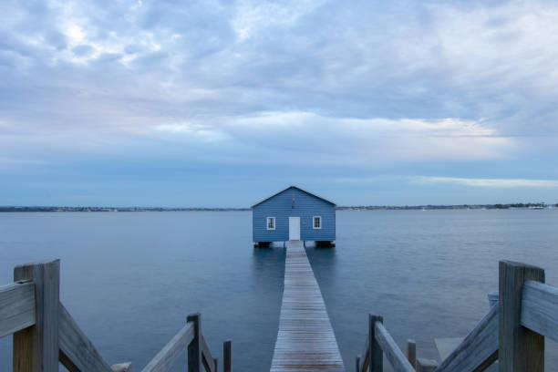 istock Blue Boat House In Perth at cloudy sunset 1058746802