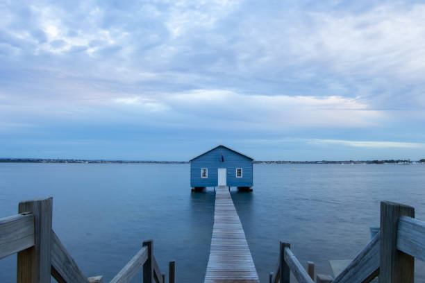 istock Blue Boat House In Perth at cloudy sunset 1058747074