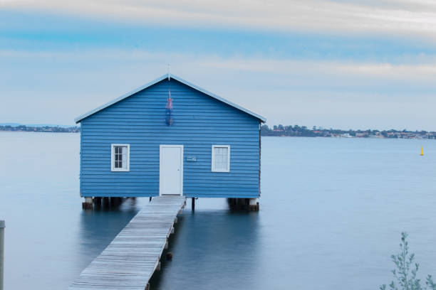 istock Blue Boat House In Perth at cloudy sunset 1058747110