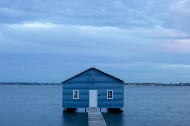 istock Blue Boat House In Perth at cloudy sunset 1058747146