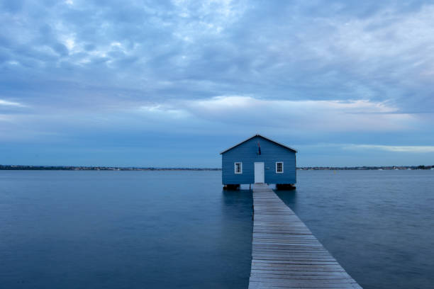 istock Blue Boat House In Perth at cloudy sunset 1058747196