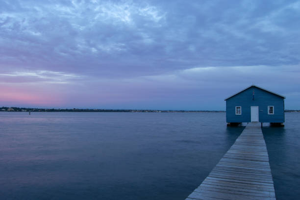 istock Blue Boat House In Perth at cloudy sunset 1058747256