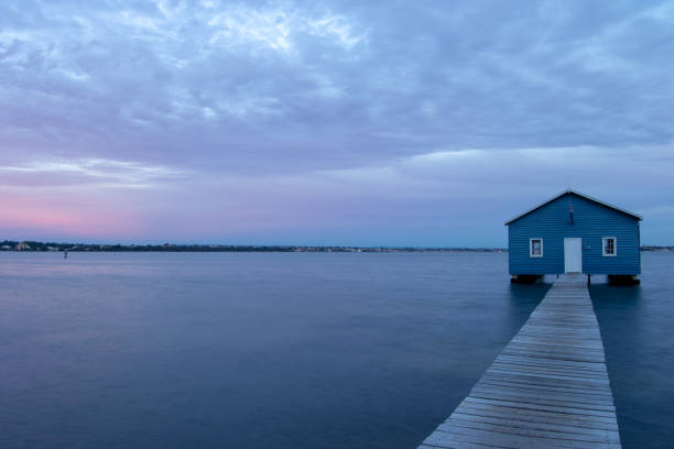 istock Blue Boat House In Perth at cloudy sunset 1058747294