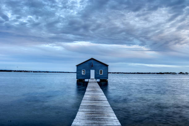 istock Blue Boat House In Perth at cloudy sunset 1058747374