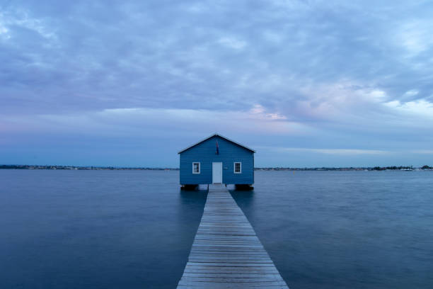 istock Blue Boat House In Perth at cloudy sunset 1058747390