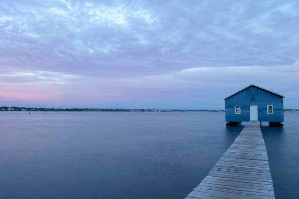 istock Blue Boat House In Perth at cloudy sunset 1058747396