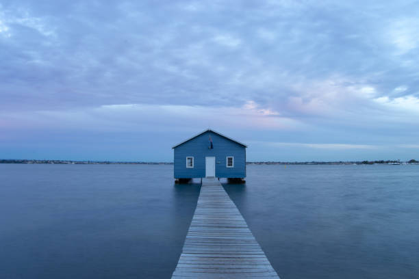 istock Blue Boat House In Perth at cloudy sunset 1058747414