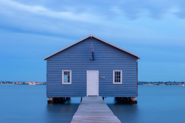 istock Blue Boat House In Perth at cloudy sunset 1058747446