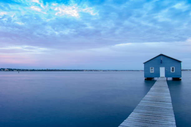 istock Blue Boat House In Perth at cloudy sunset 1058747450