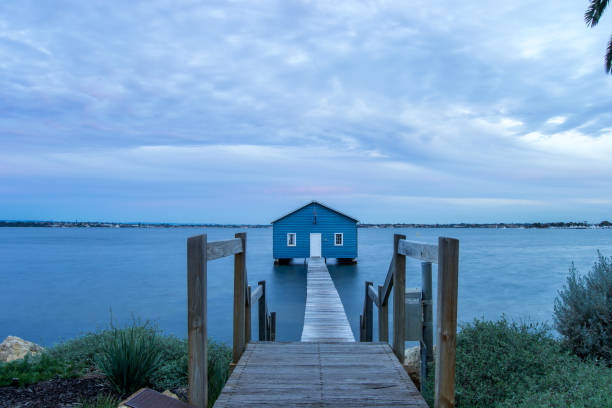 istock Blue Boat House In Perth at cloudy sunset 1058748466