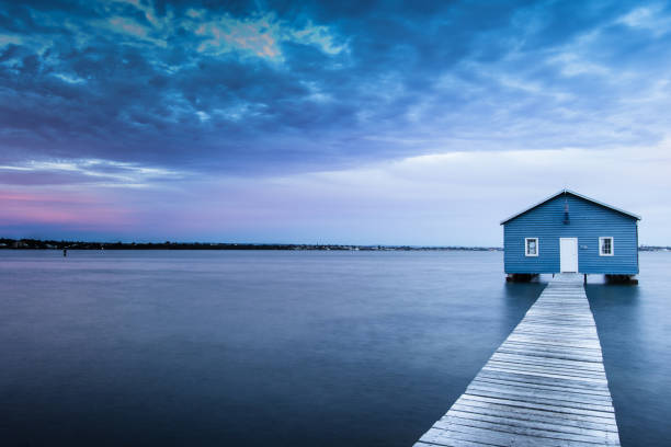istock Blue Boat House In Perth at cloudy sunset 1058748476