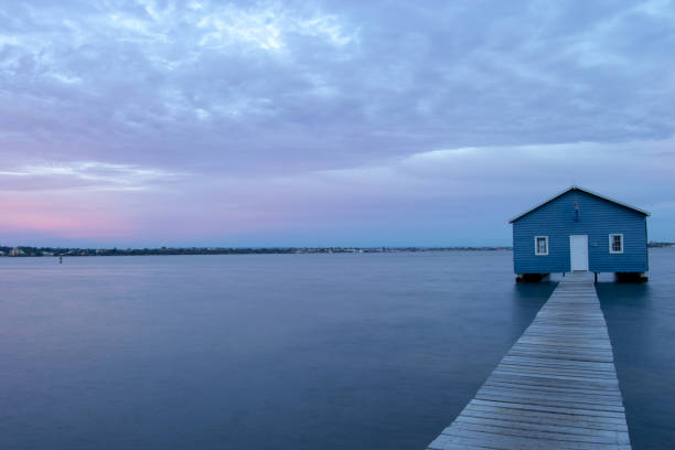 istock Blue Boat House In Perth at cloudy sunset 1058748500