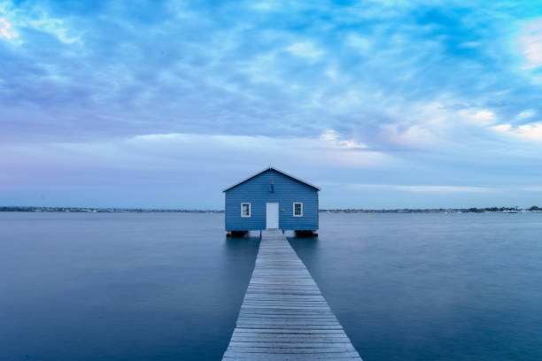 istock Blue Boat House In Perth at cloudy sunset 1058748510