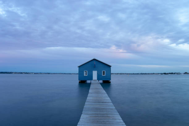 istock Blue Boat House In Perth at cloudy sunset 1058748570