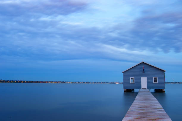 istock Blue Boat House In Perth at cloudy sunset 1058748610
