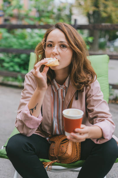 istock Woman sitting on patio and drinking coffee 1058749882