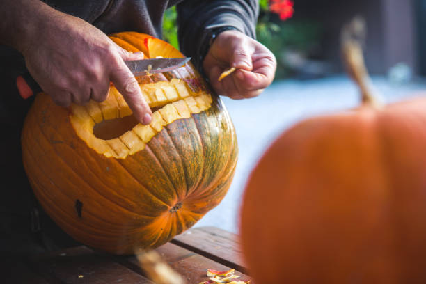 istock Carving out a pumpkin to prepare halloween lantern 1058750936