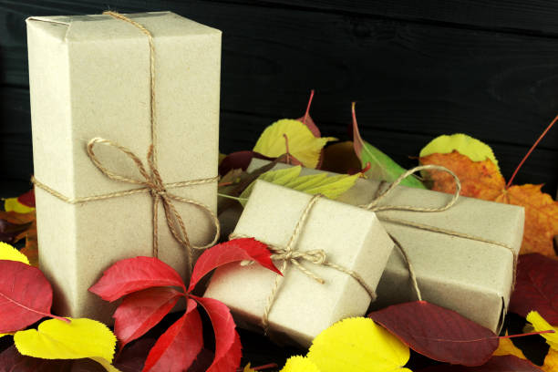istock three gift boxes in the fall leaves are colored, on a dark village background 1058752550