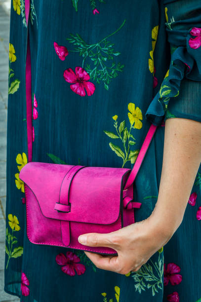 istock A young woman holding a small pink bag 1058754786