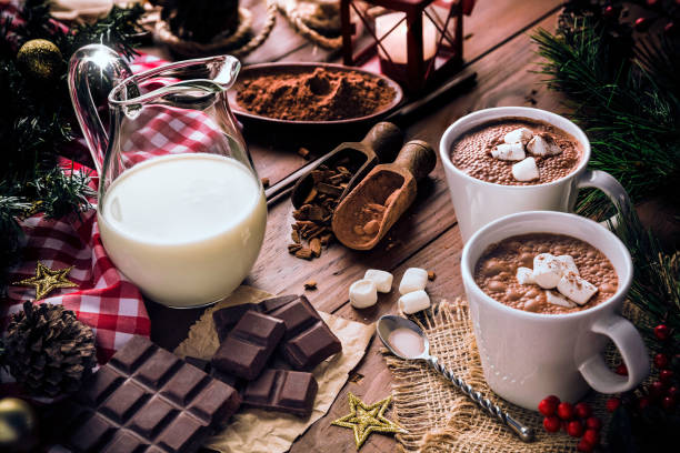 istock Christmas table setup with homemade two chocolate mug with marshmallows and candlelight lamp 1058757392