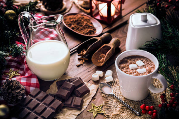 istock Christmas table setup with homemade chocolate mug with marshmallows and candlelight lamp 1058758578