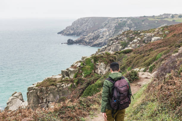 istock Man out walking along the Cornish coast at Penn Vounder 1058758876
