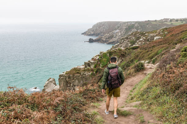 istock Man out walking along the Cornish coast at Penn Vounder 1058758900