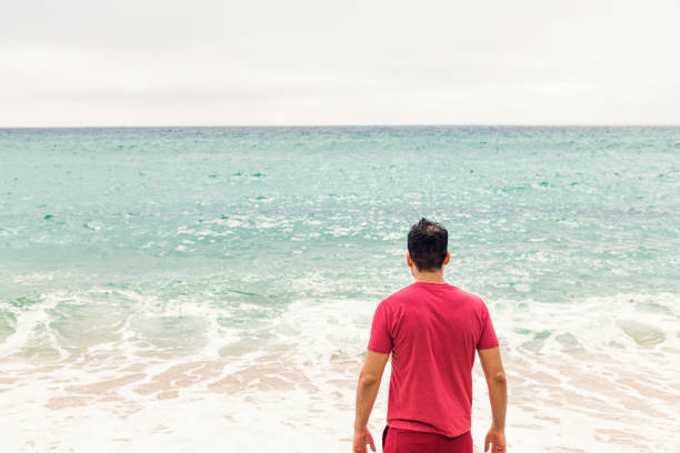 istock man in red enjoying the coast 1058758940