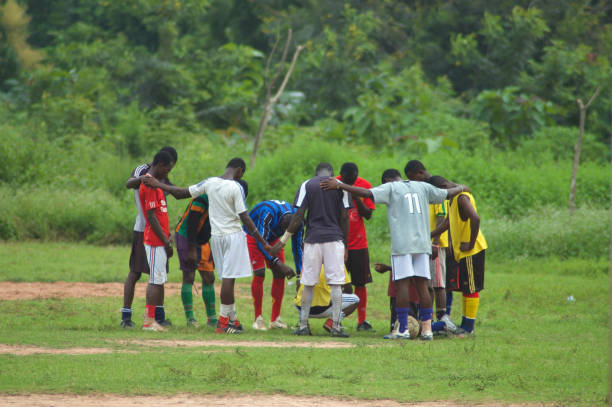 Football players praying, Ghana stock photo