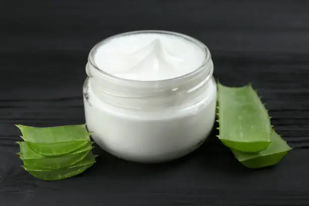 Photo of cosmetic cream lotion with natural green fresh aloe vera