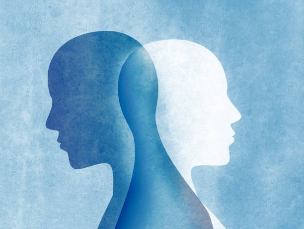 Bipolar disorder mind mental. Split personality. Mood disorder. Dual personality concept. Silhouette on blue background Bipolar disorder concept with two silhouettes of man standing back and intersecting each other on a blue background bipolar disorder stock illustrations