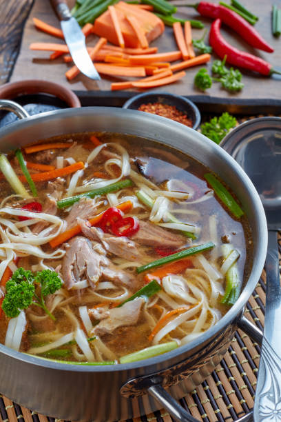istock duck noodle vegetables soup, top view 1058767660