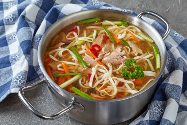 istock poultry noodle vegetables soup, top view 1058767764