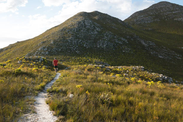 istock Fit male running along a mountain path 1058770720