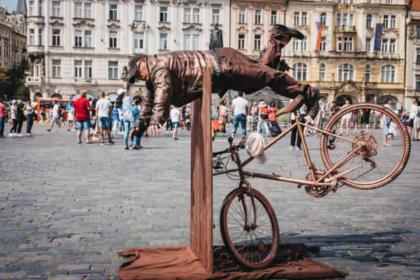 Prague, Czech Republic - August 23, 2018: Living statue, a street artist posing as a statue for hours at a time, in Old Town Square, a historic square in the Old Town quarter of Prague.