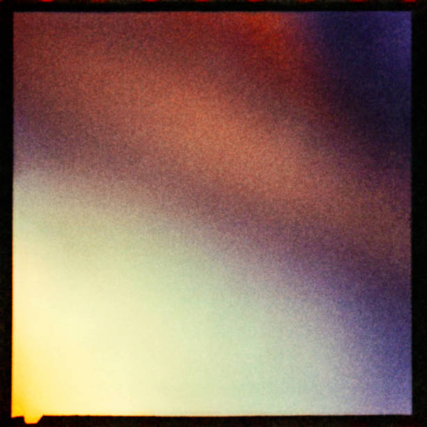 istock Colorful textured background with light leaks and grain. 1058775856
