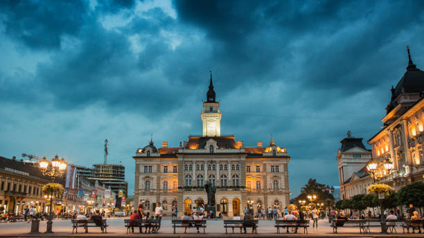 Center of Novi Sad at evening Novi Sad, Serbia - September 03, 2018: Evening at Novi Sad, with people passing by and sitting serbia stock pictures, royalty-free photos & images