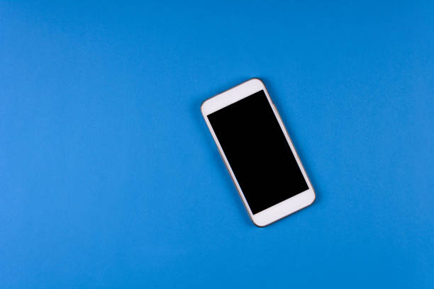 istock Mock-up smartphone on blue background. Flat lay. Copy space. Top view 1058777246