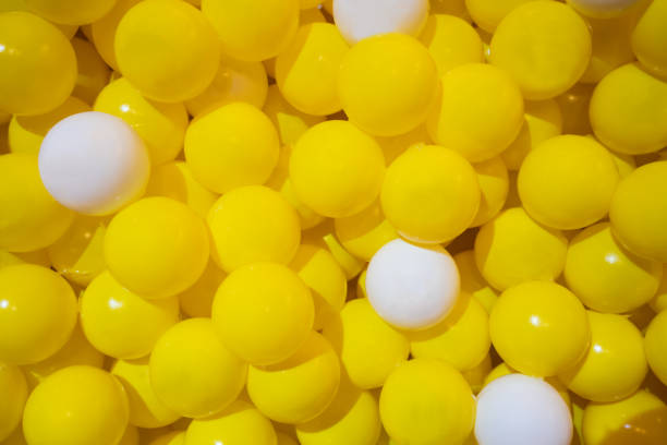 istock Yellow and white plastic balls for texture and background. 1058779534