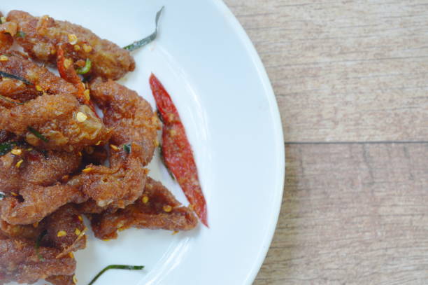 istock deep fried chicken skin with chili and ginger sauce 1058793804