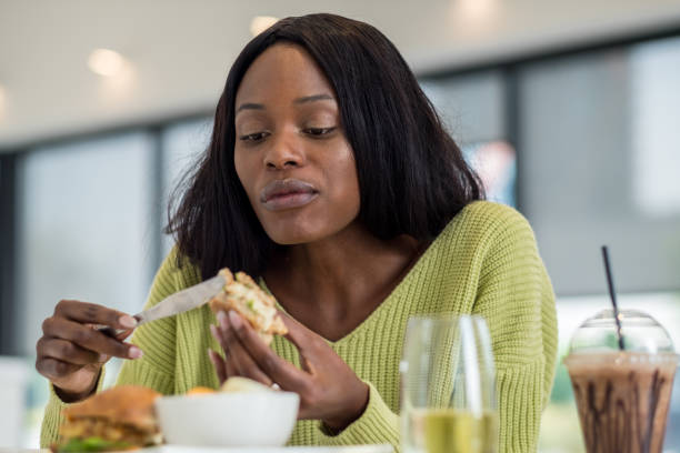 istock Young black woman at lunch 1058794440