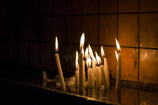 istock Lit Candles in Church Interior at Christmas 1058794544