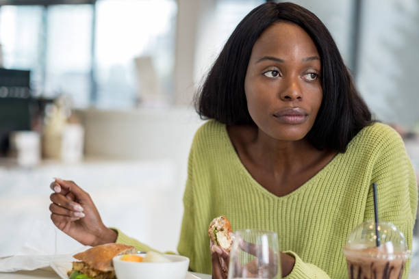 istock Young black woman at lunch 1058796212