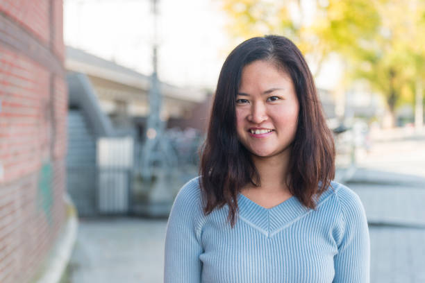 istock Cheerful Asian woman in Amsterdam 1058796810