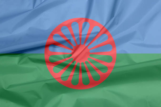 Fabric flag of Romani people. Crease of the Gypsies flag background. stock photo