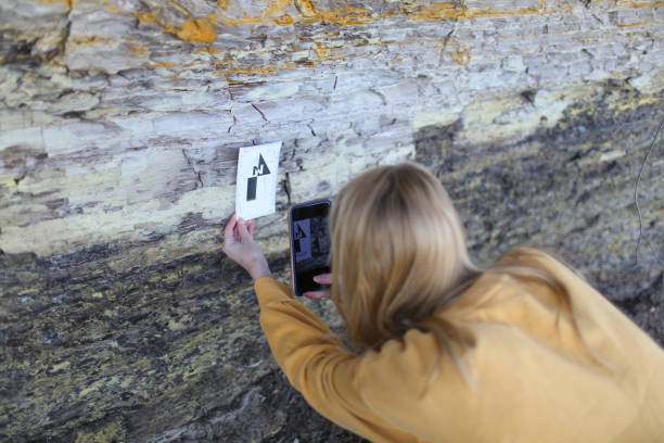 istock Final year female Geology student examining coastal rock samples as part of her final year Geology dissertation on sea level changes in the UK 1058799326