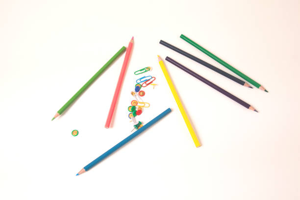 istock colorful pencils with paperclips on white desk 1058802832
