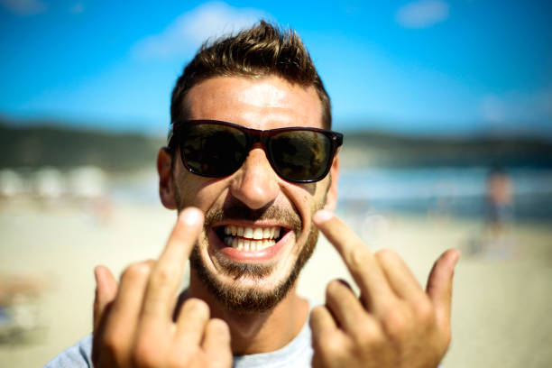 istock Young man shows the middle finger 1058805878